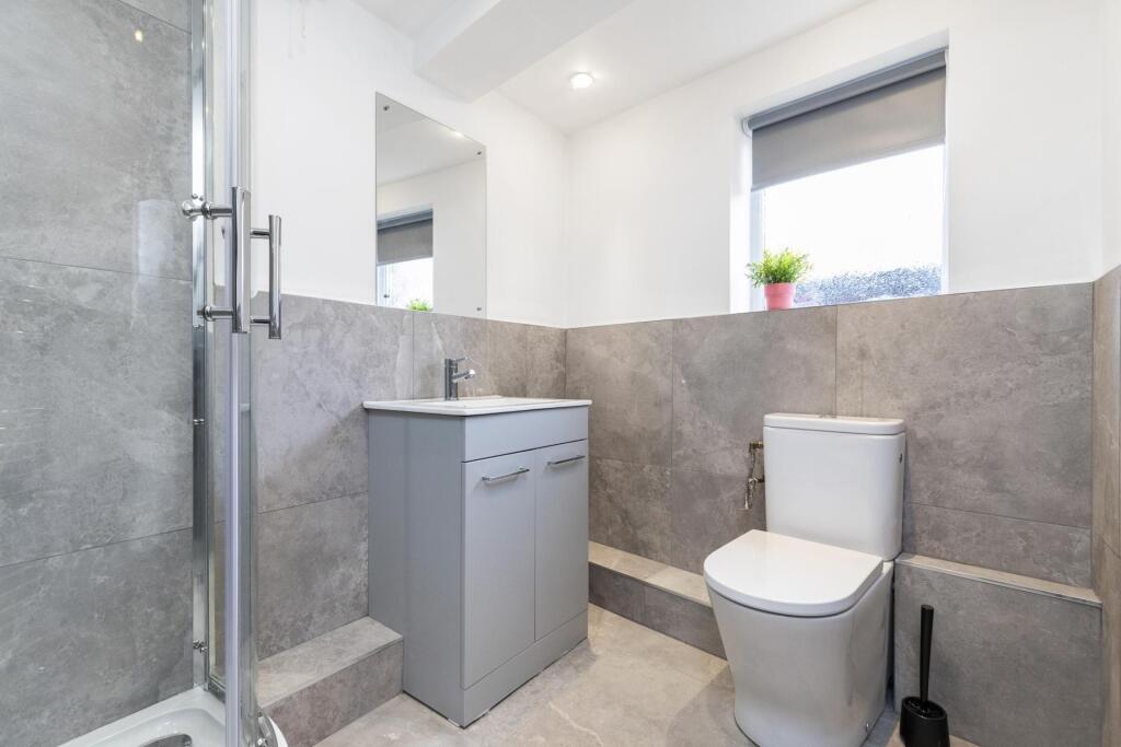 Bright, modern bathroom with a walk-in shower, ...