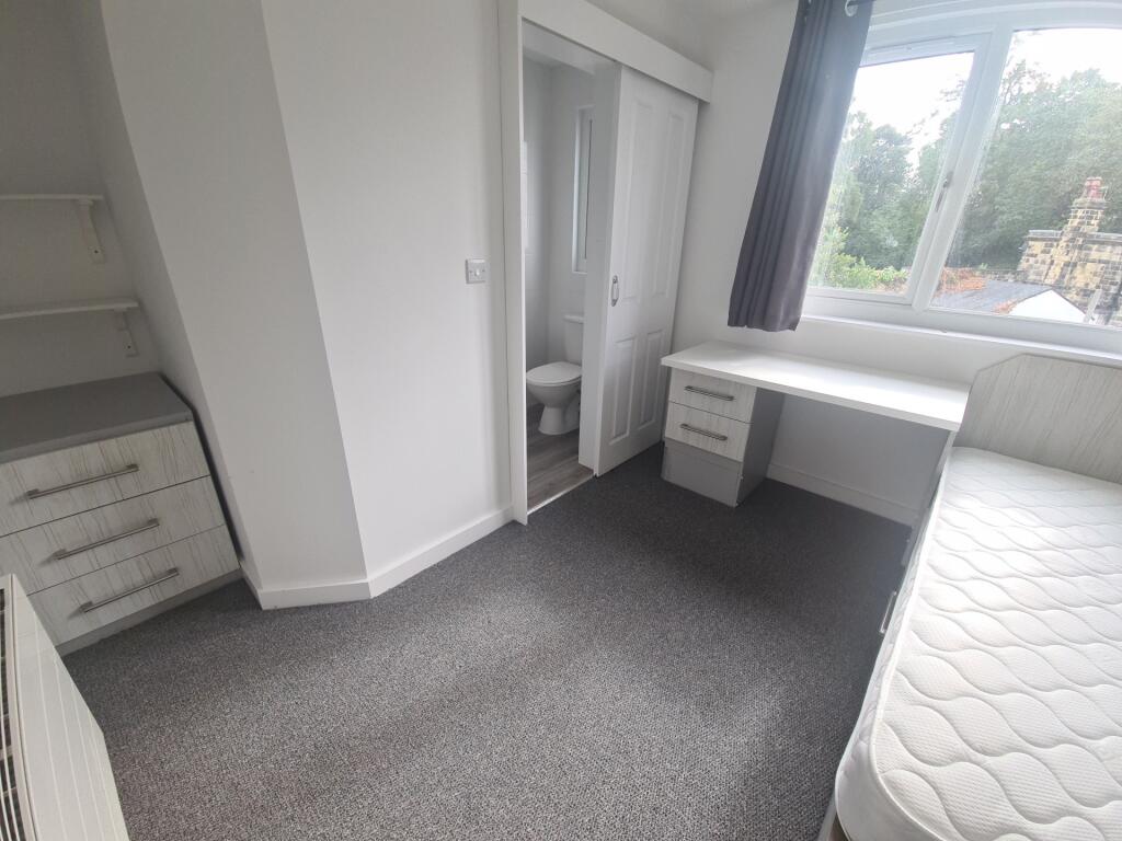 Bright and tidy single bedroom featuring a larg...