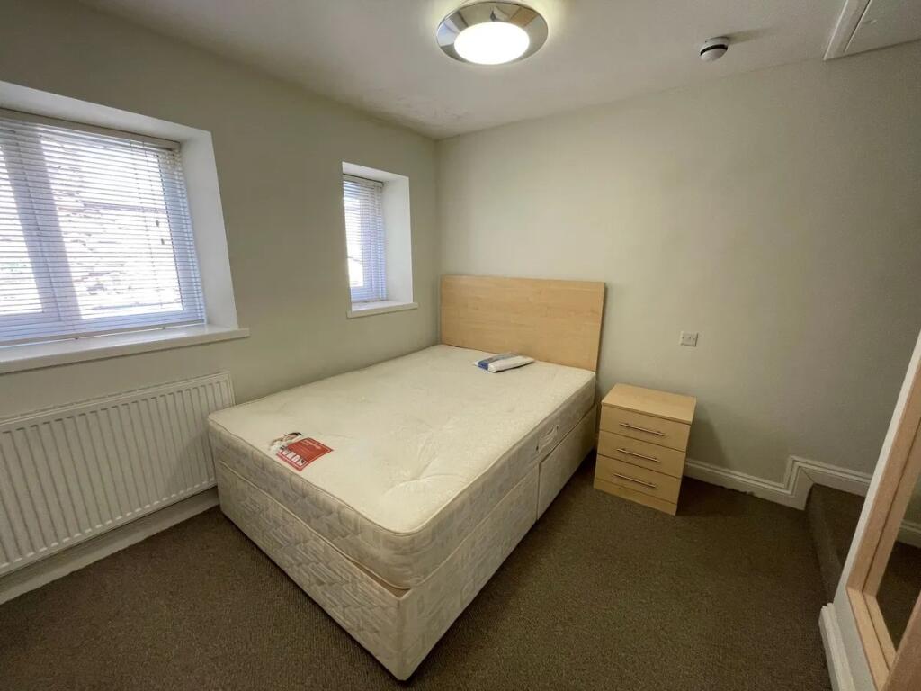 Bright and tidy double bedroom featuring a comf...