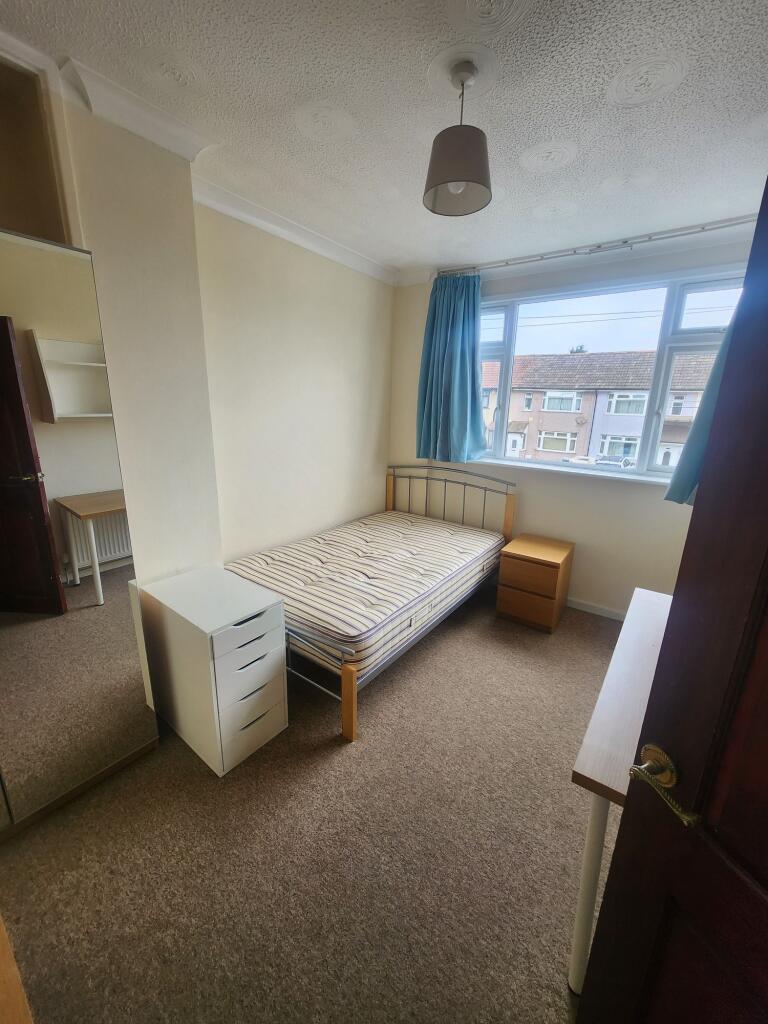 A bright and tidy single bedroom featuring a la...