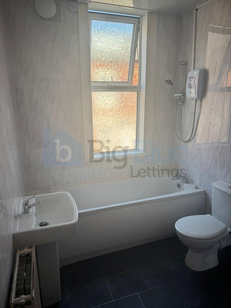 This stylish bathroom features a modern design ...