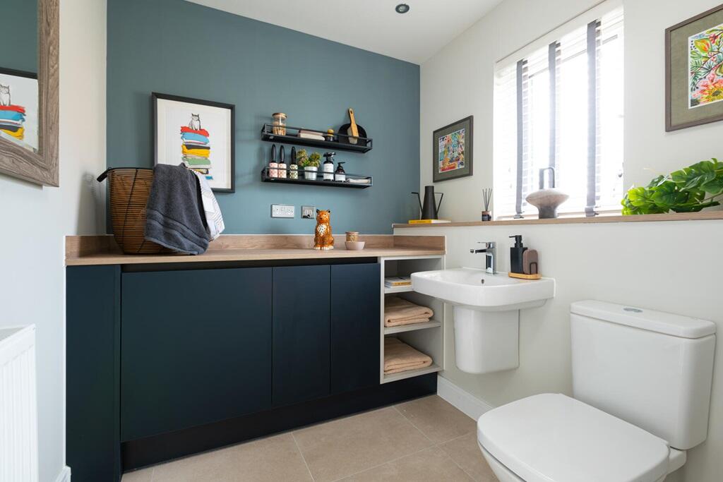 A guest cloakroom also hosts space for laundry appliances
