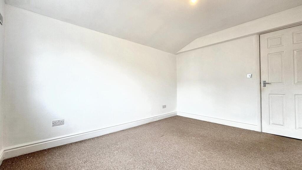 A bright and inviting double bedroom with ample...