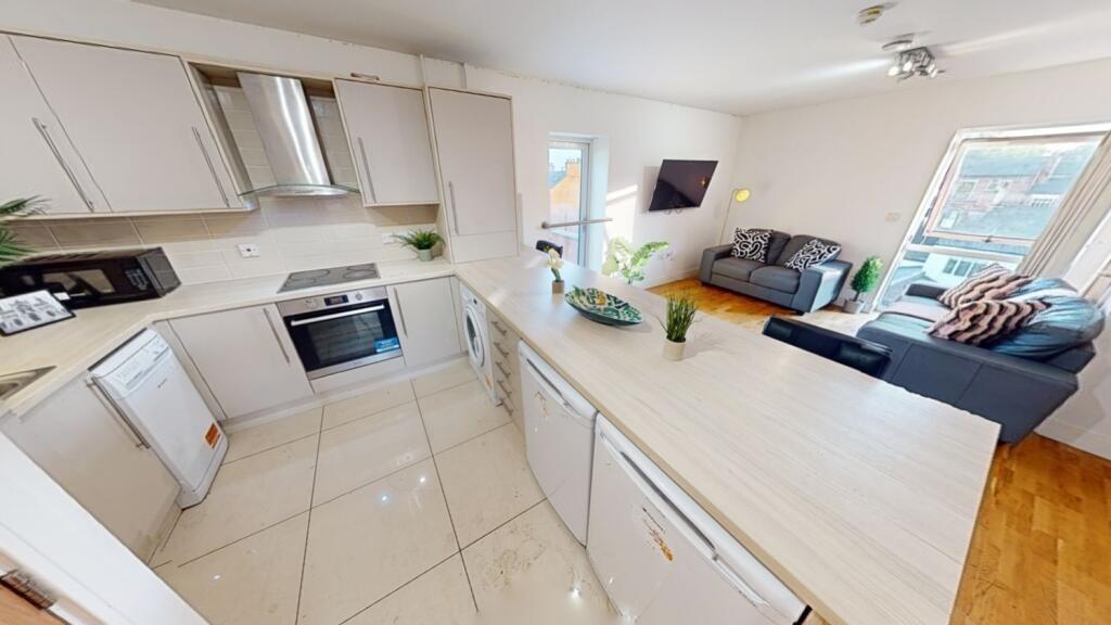 A bright and modern open-plan living room with ...