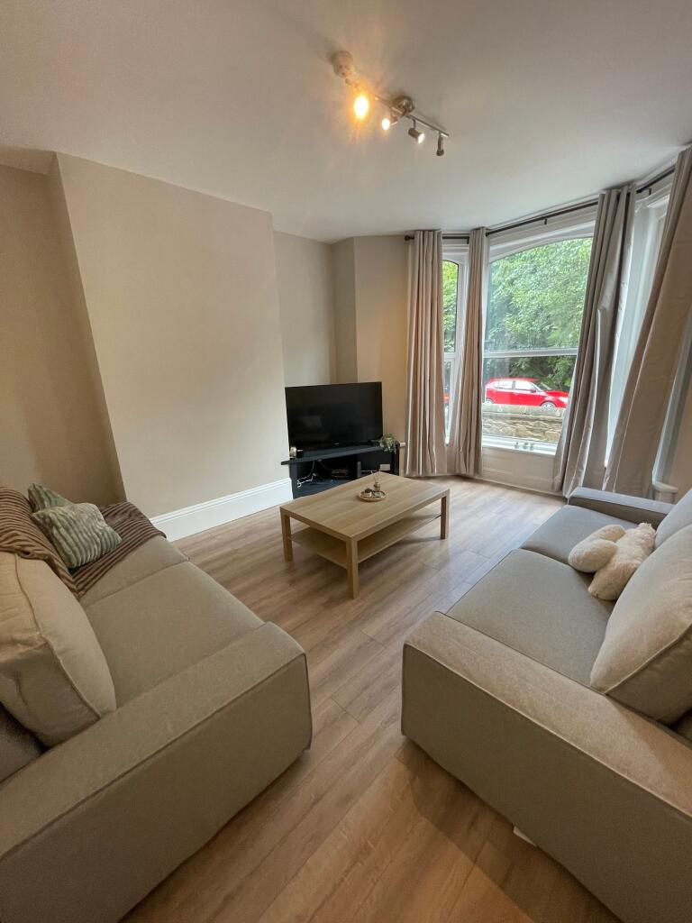 Bright and welcoming living room with large win...