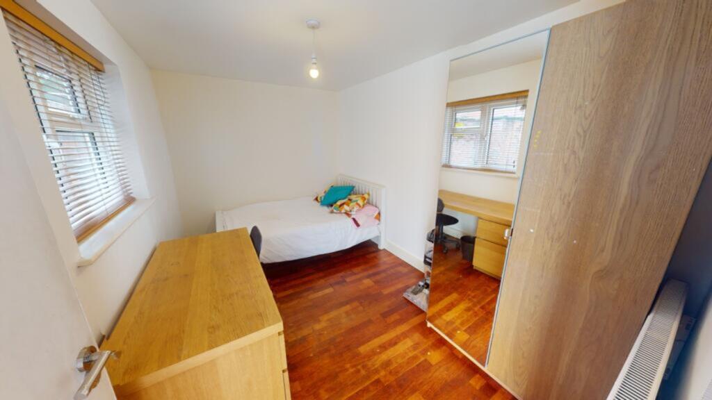 A bright and spacious double bedroom featuring ...