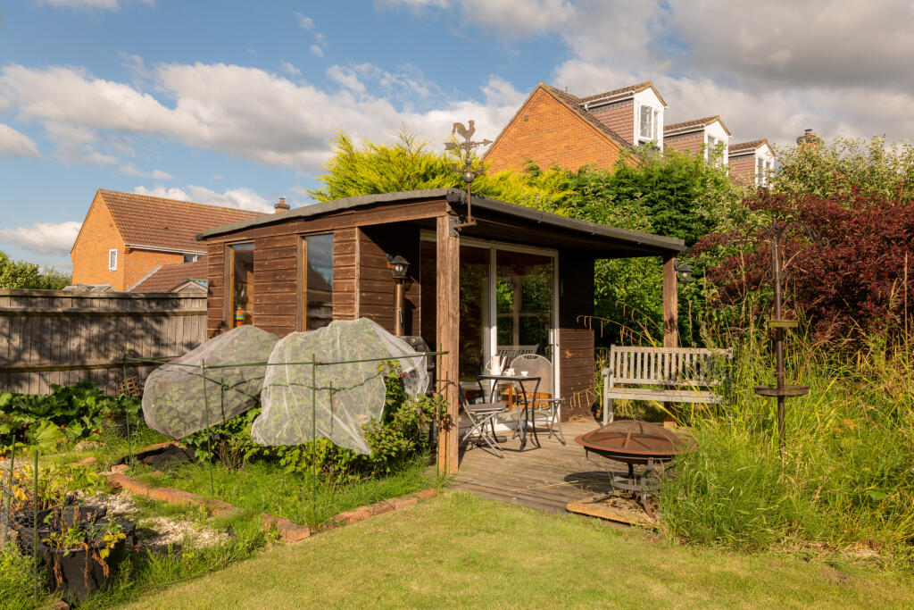 Summer house next to herb garden and orchard