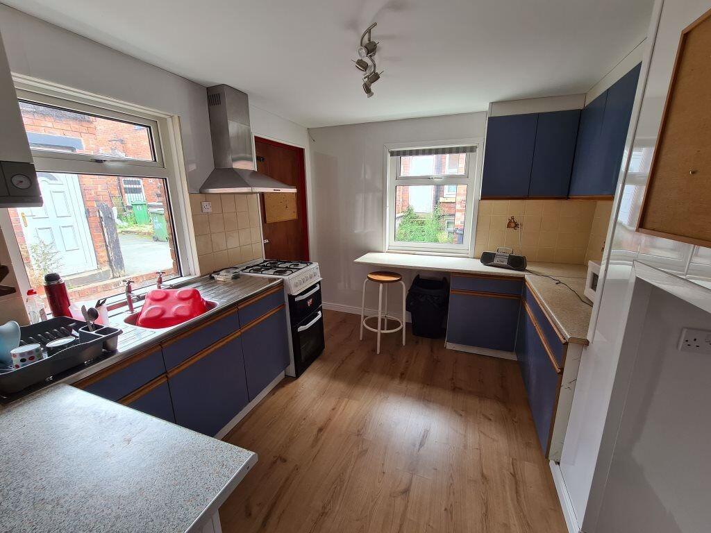 Bright and modern kitchen featuring ample count...