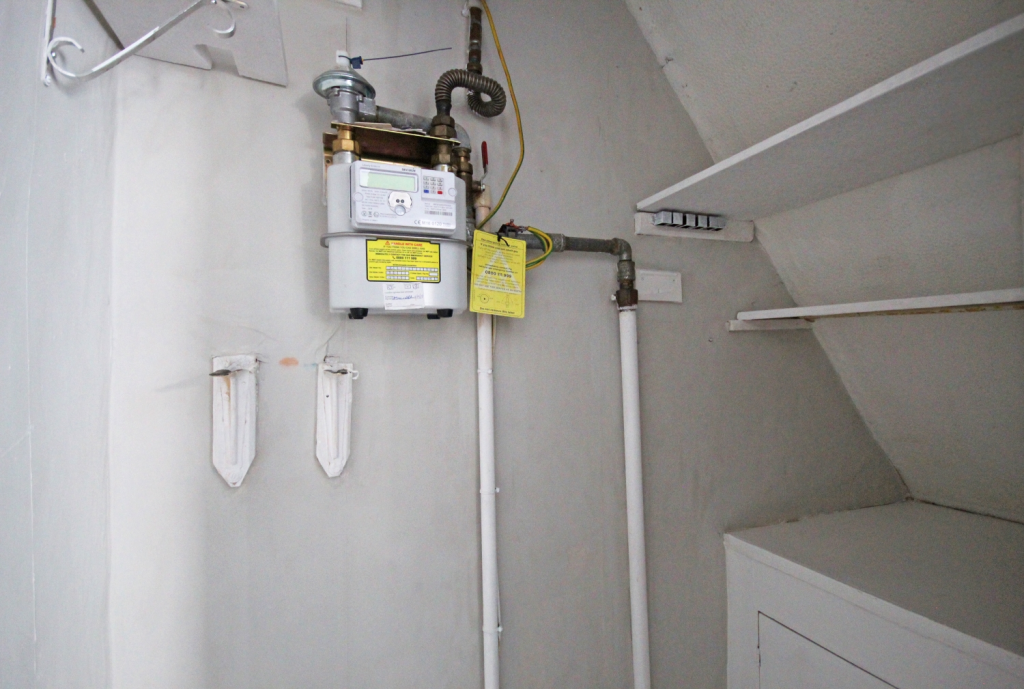 Understairs storage with shelves within the dining