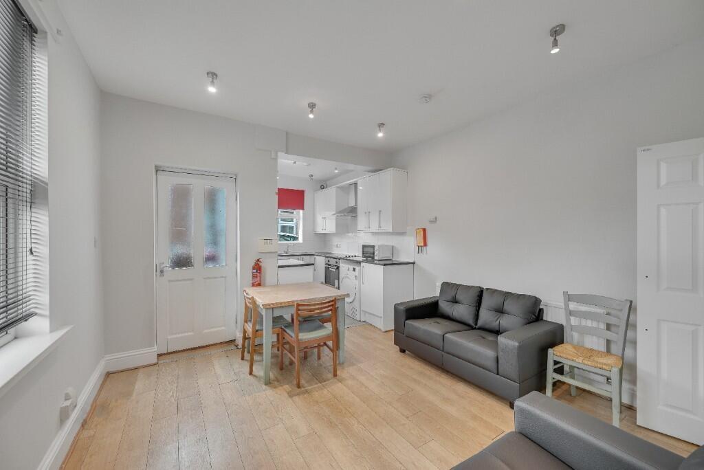Bright and modern kitchen area featuring white ...