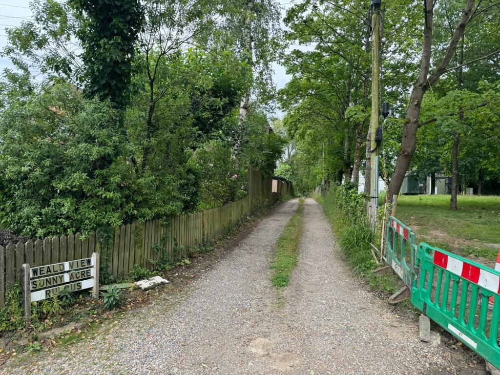 ACCESS ROAD LEADING TO THE PLOT