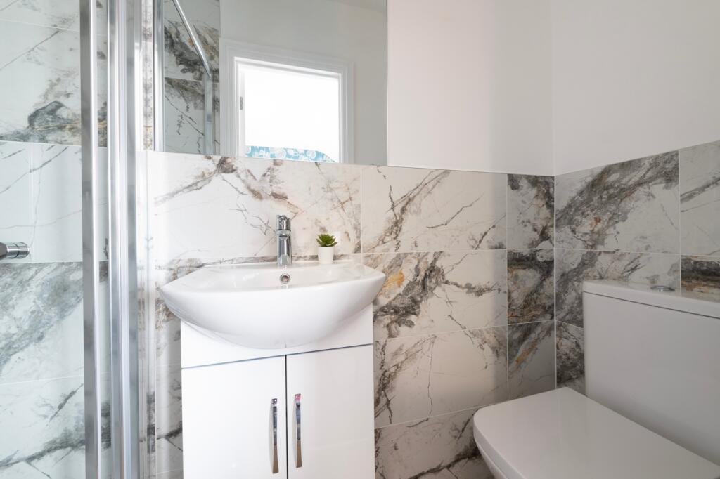 A modern and stylish bathroom featuring elegant...