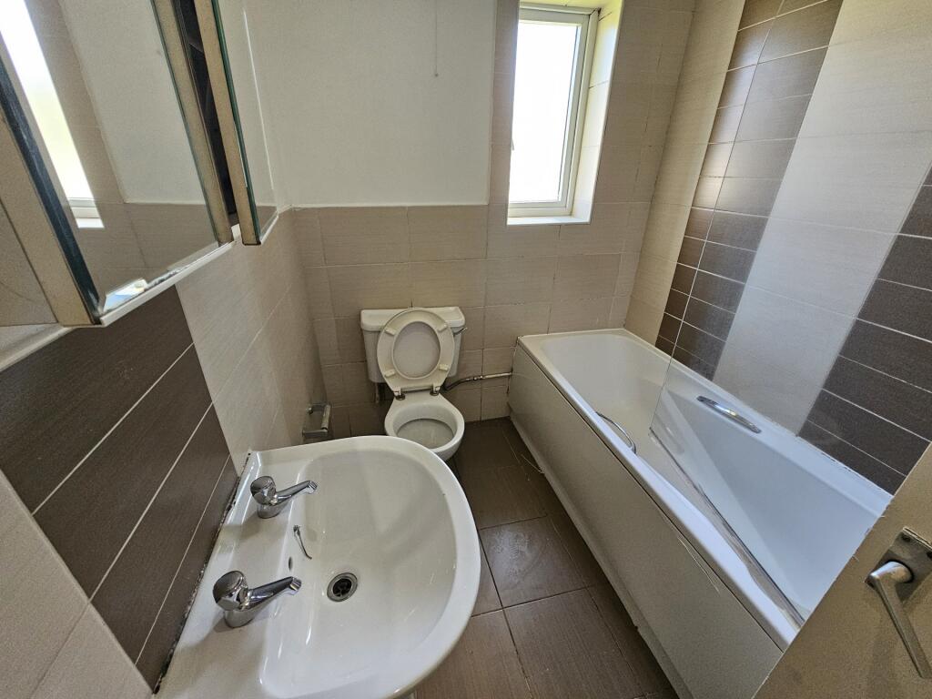 A clean and modern bathroom featuring a white b...