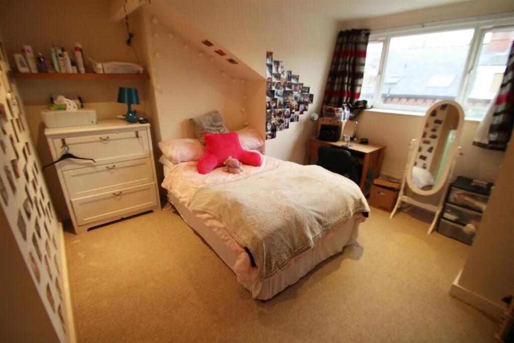 Cozy double bedroom featuring a comfortable bed...