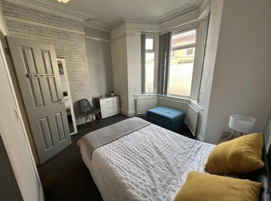 Bright and cozy double bedroom featuring a comf...