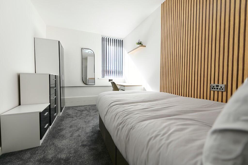 Bright and modern single bedroom featuring a co...