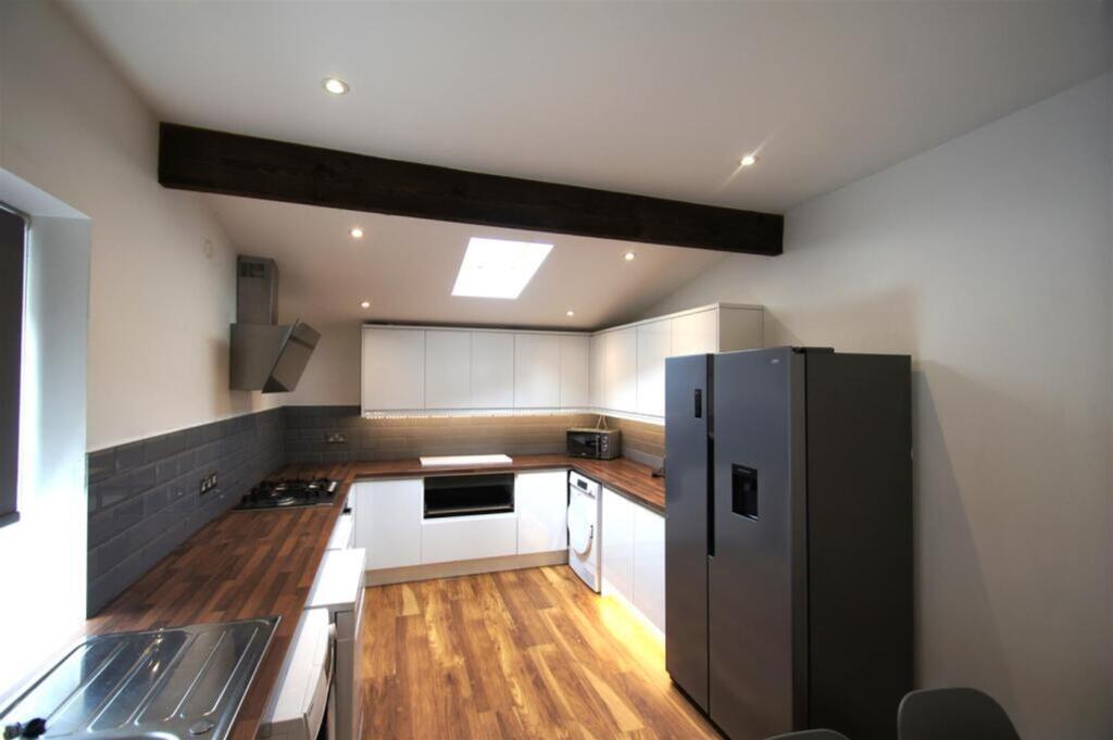Stylish and modern kitchen featuring sleek cabi...