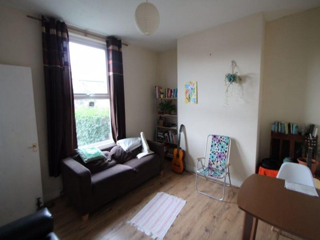 A well-maintained living room with ample natura...