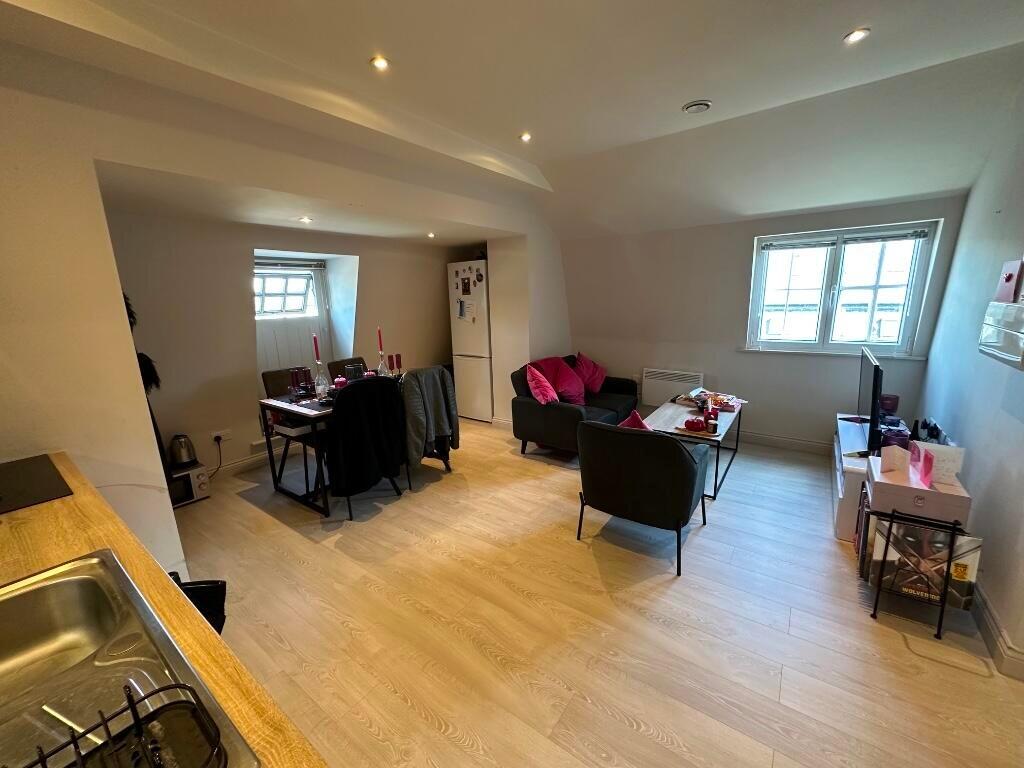 A modern, well-kept living room with ample seat...