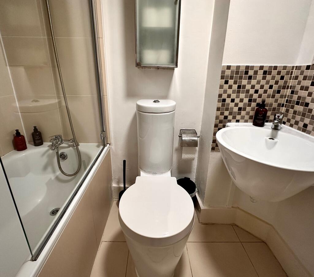 Bright and clean bathroom featuring a modern wh...