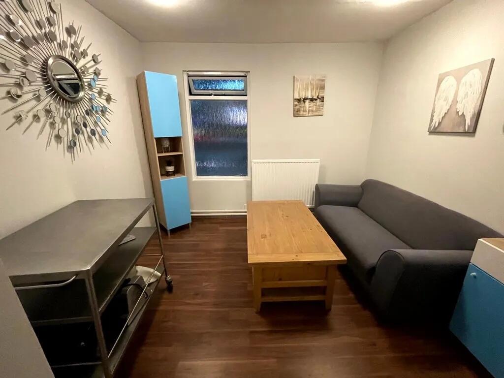 A neat and cozy living room featuring a comfort...