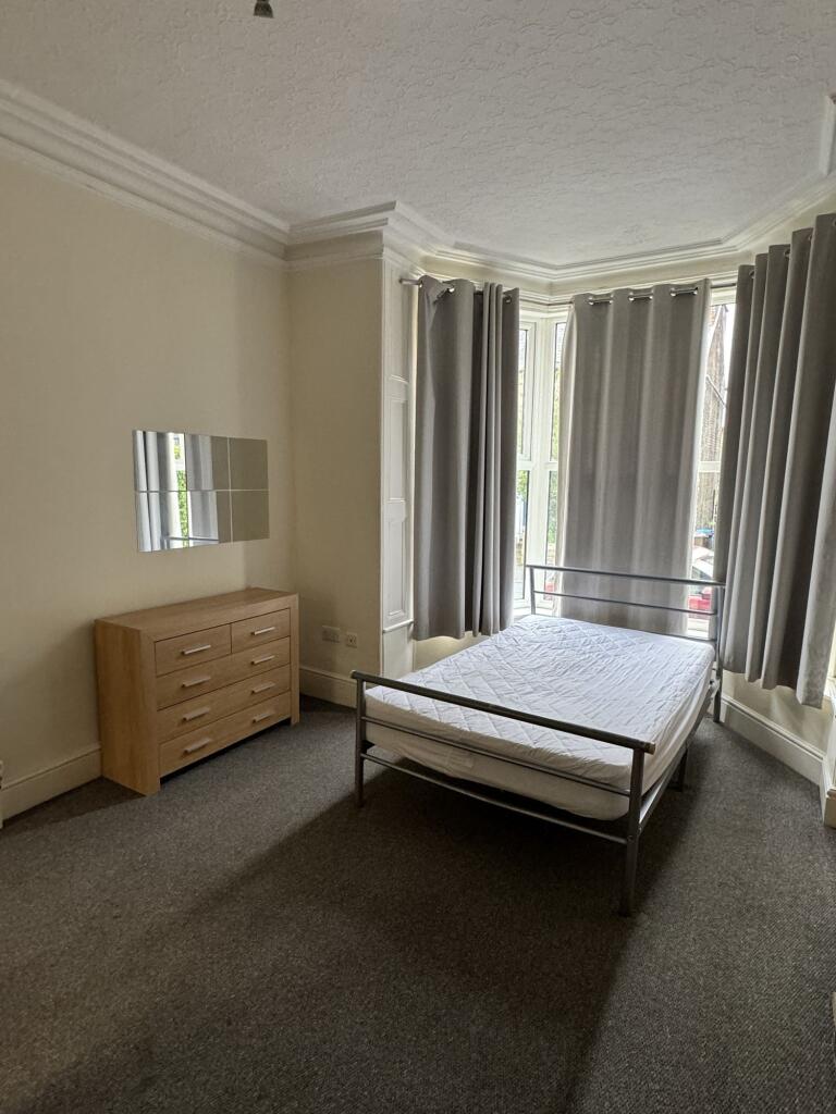 A neatly maintained, modestly sized bedroom fea...