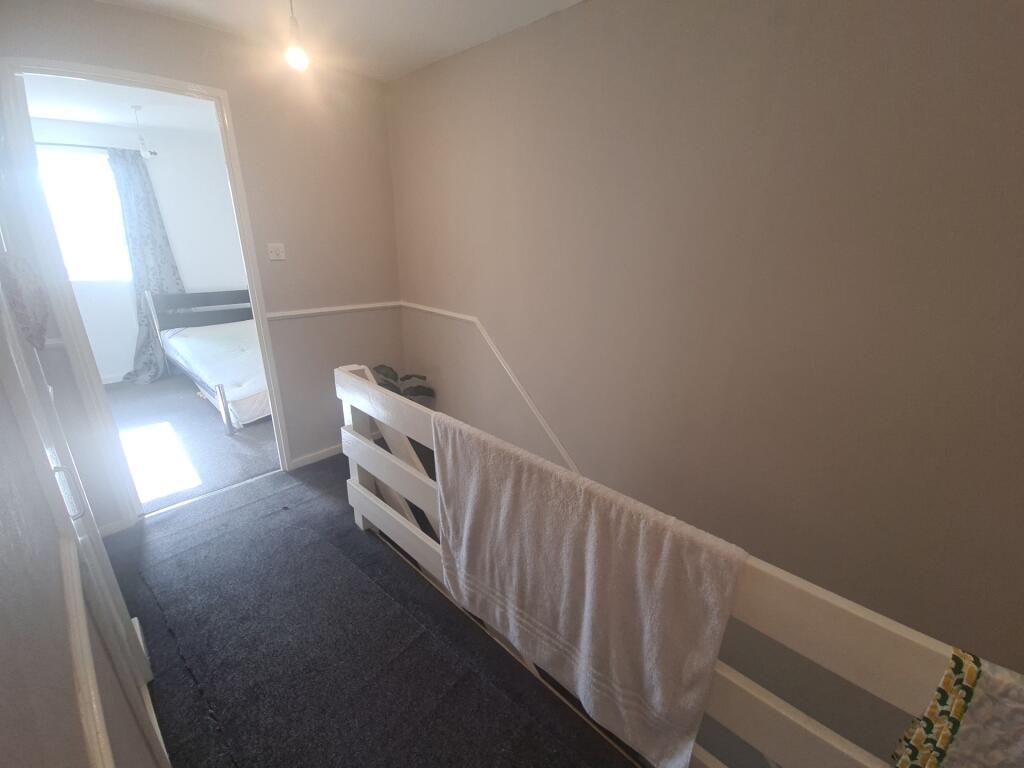 A clean, well-maintained hallway featuring neut...