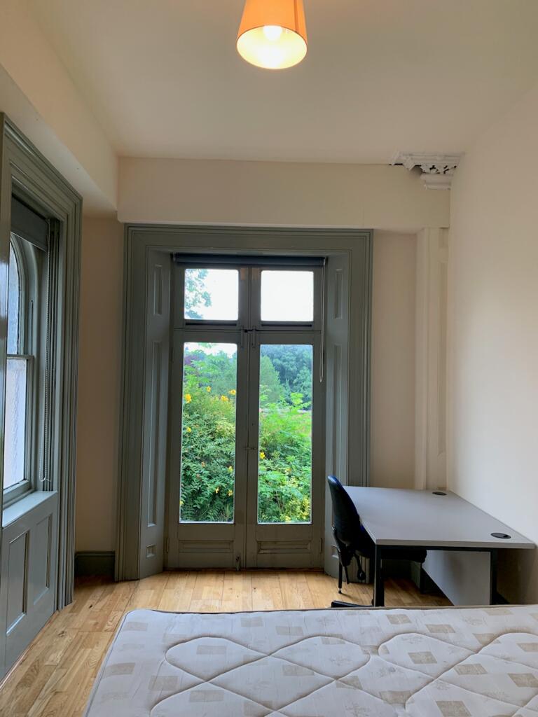 A bright and inviting double bedroom featuring ...