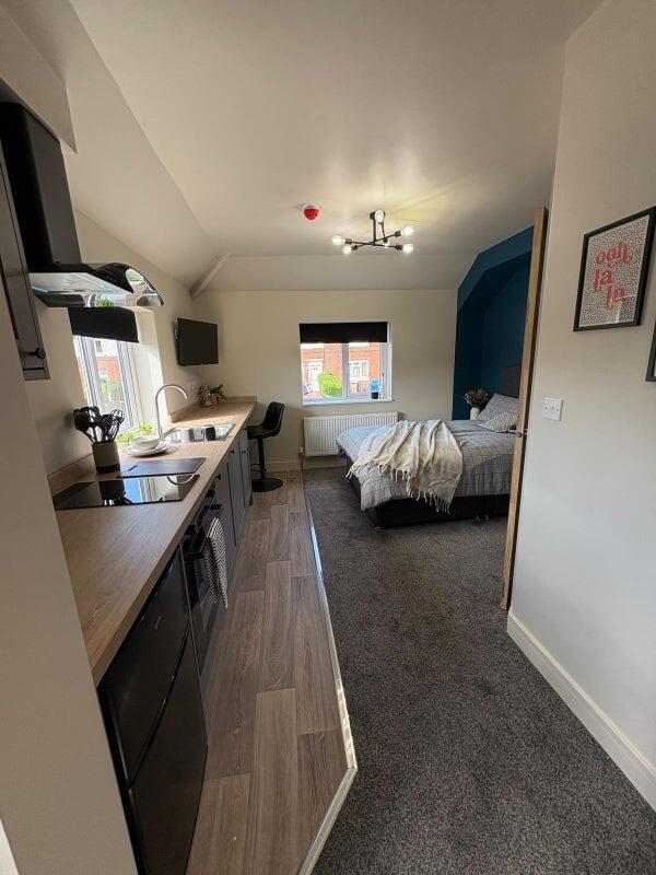 A modern and well-maintained studio bedroom fea...