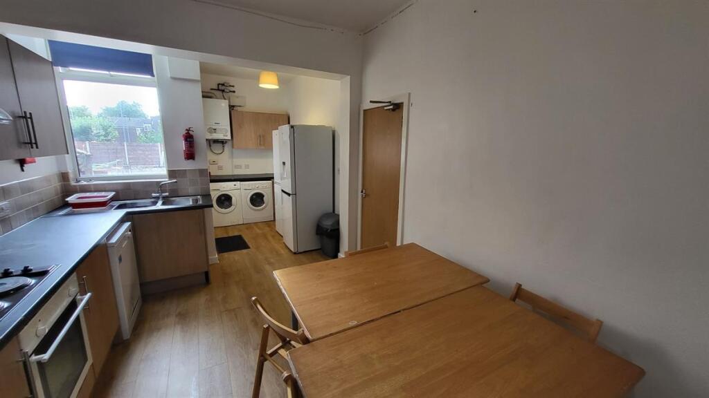 A bright and functional kitchen featuring woode...