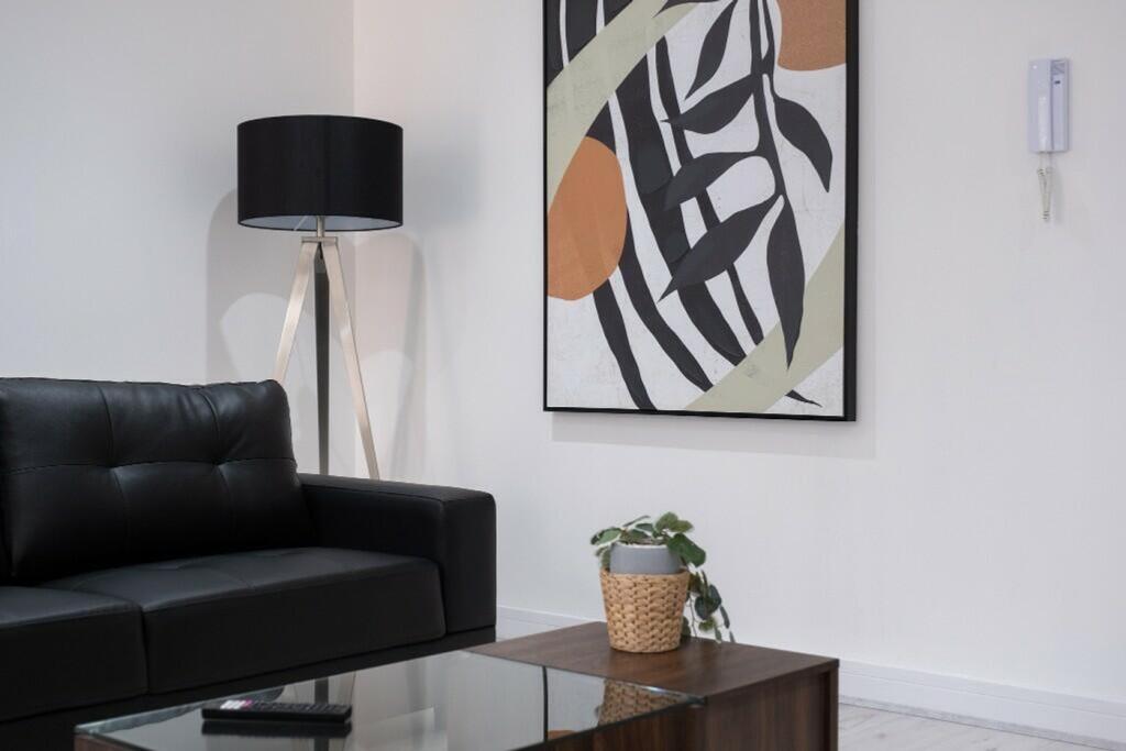 A stylish living room featuring a sleek black s...