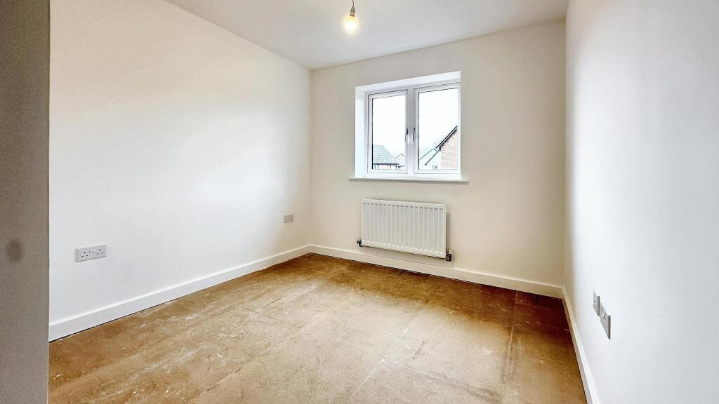 This inviting double bedroom features a bright ...