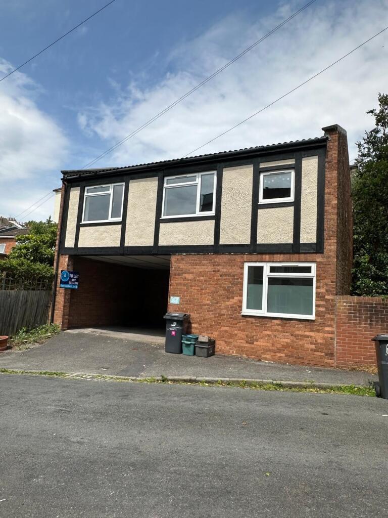 A semi-detached house with a brick lower facade...