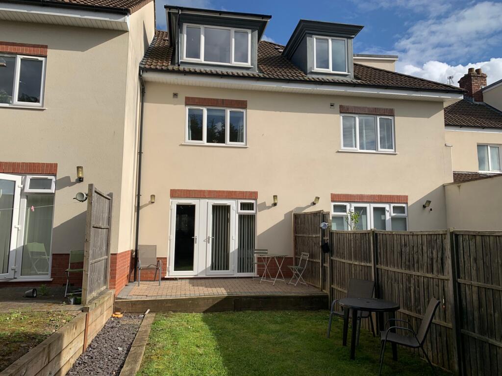A spacious and well-maintained garden area, per...