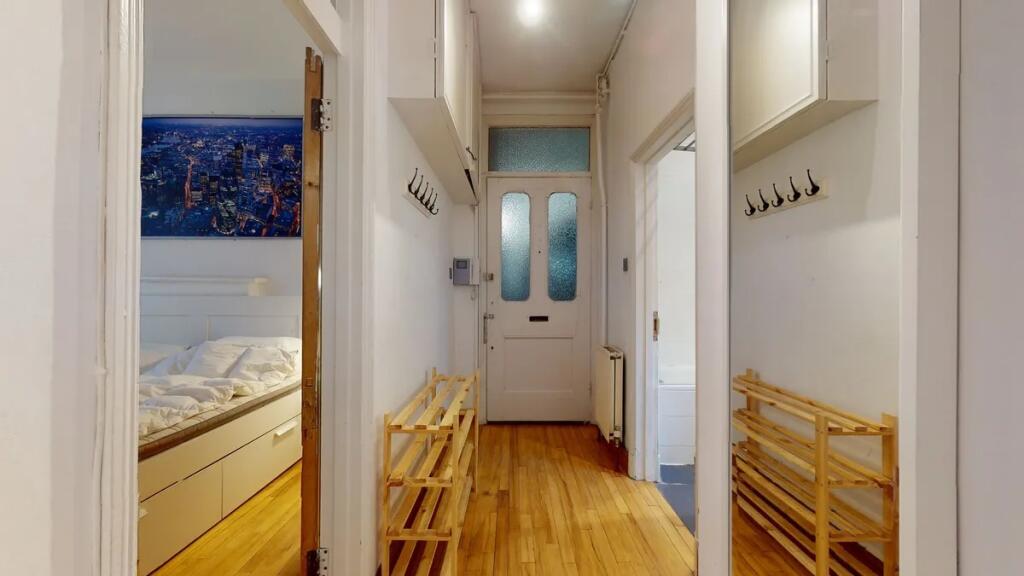 Bright and tidy hallway featuring polished wood...