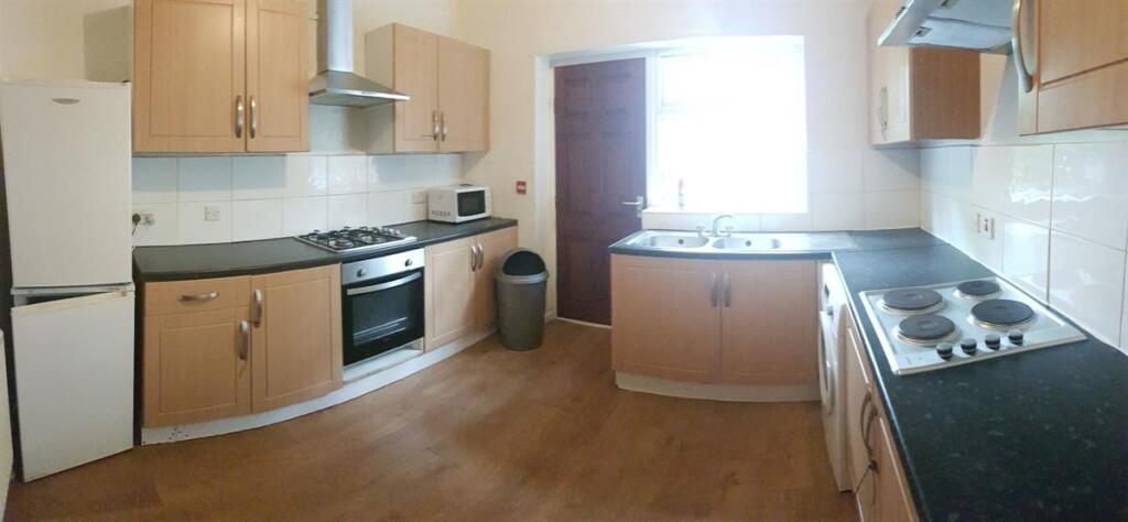 A well-maintained kitchen with natural light co...