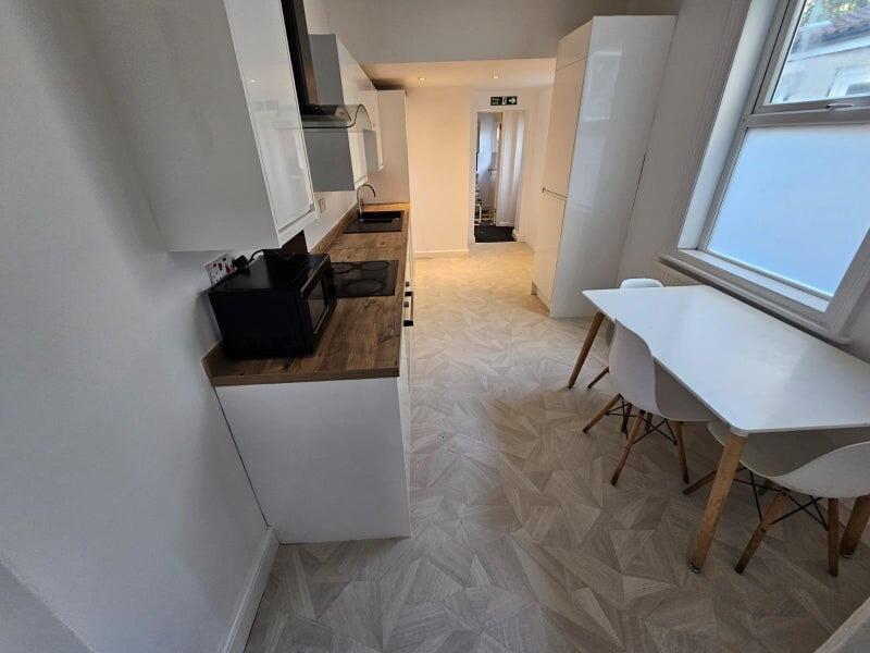 Bright and modern kitchen featuring sleek white...
