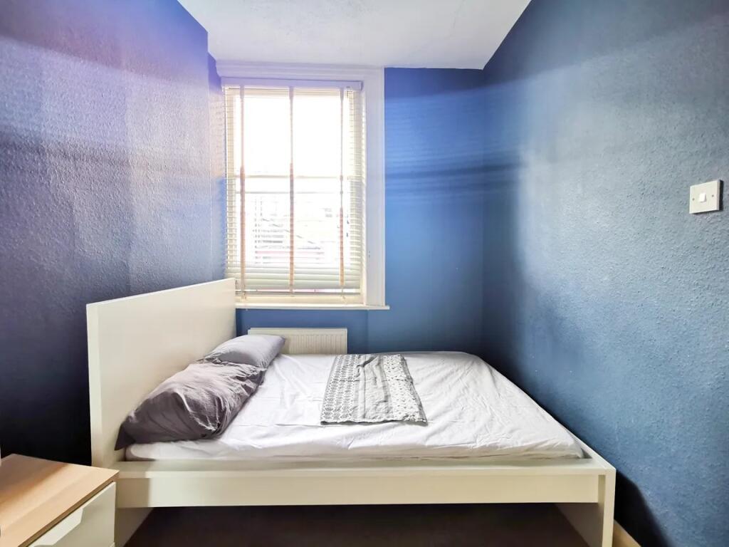 A cozy double bedroom featuring a clean white b...