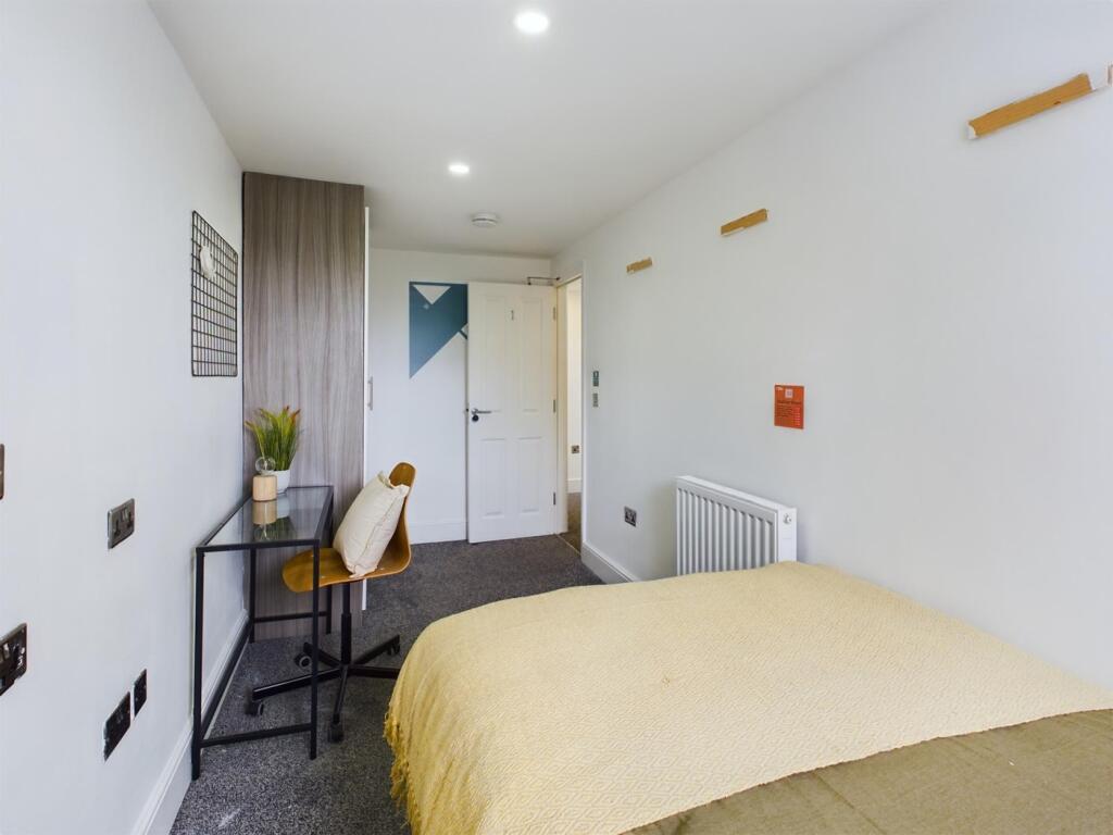 A bright and spacious double bedroom featuring ...