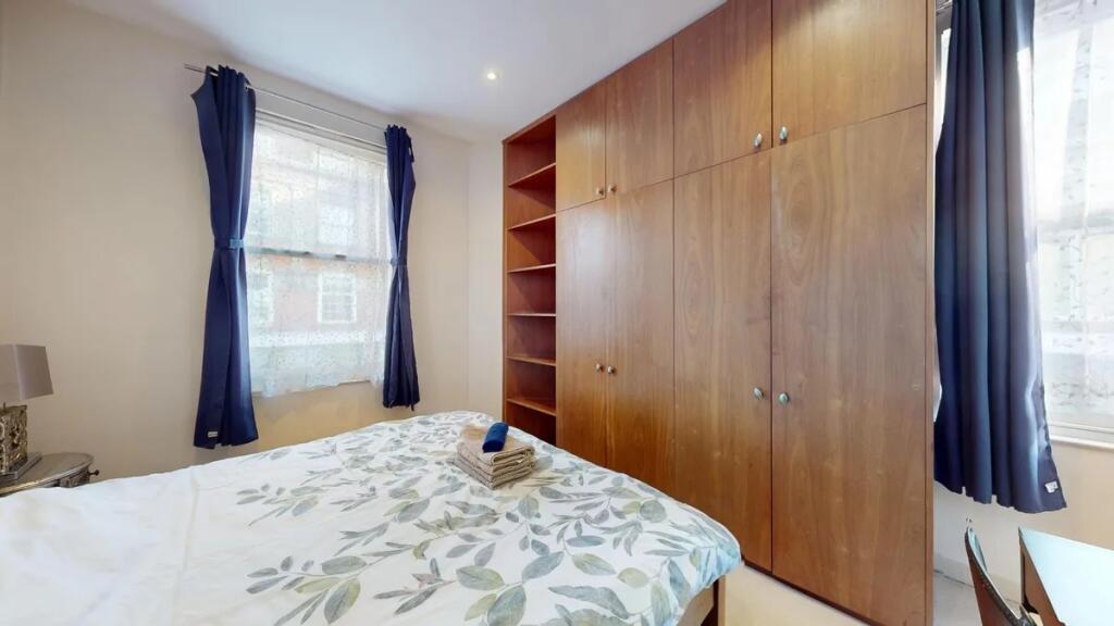 Bright and tidy double bedroom featuring large ...