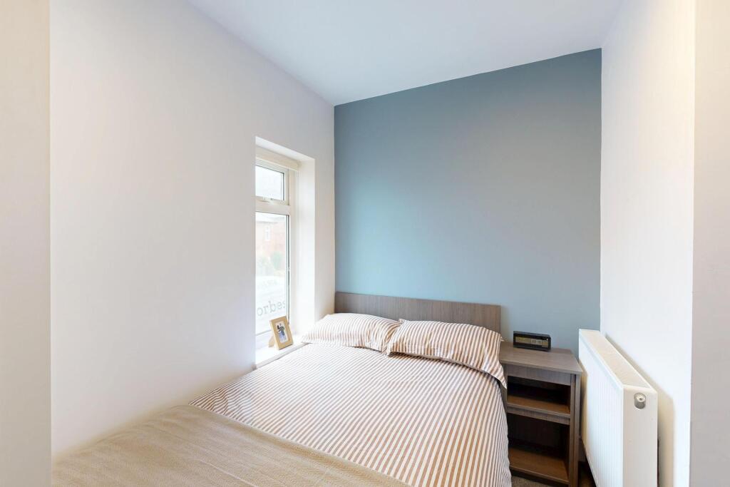 A bright and tidy double bedroom with a comfort...