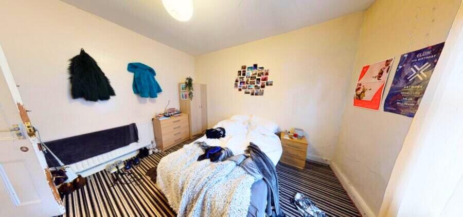 Cozy double bedroom featuring a comfortable bed...