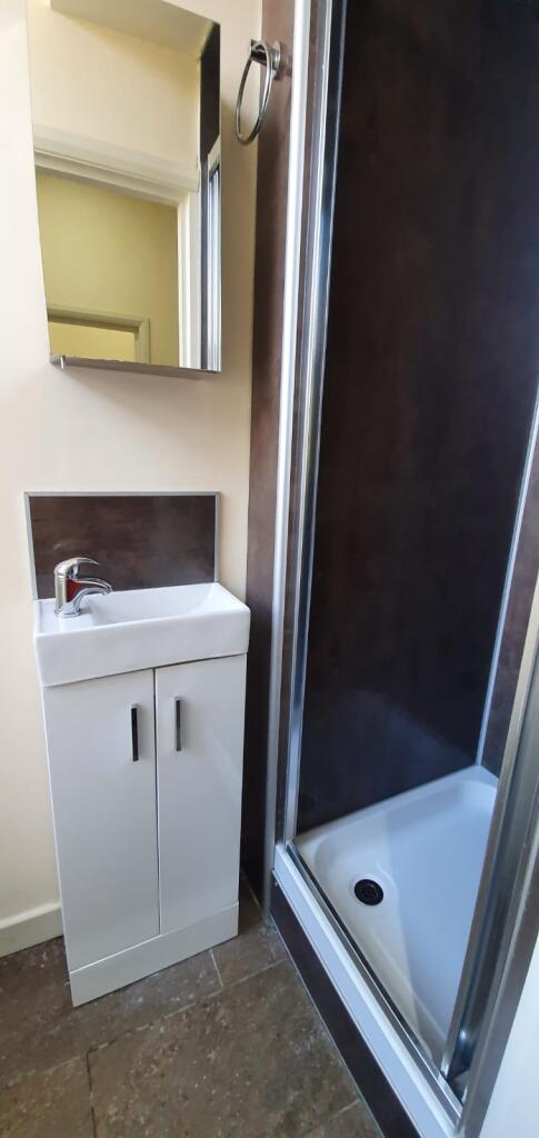 Compact and modern bathroom featuring a sleek w...