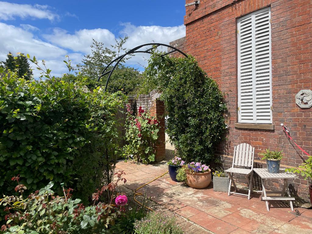 Archway to parking and front door