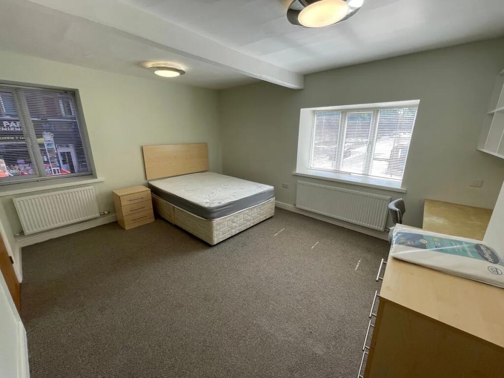 A bright and spacious double bedroom featuring ...