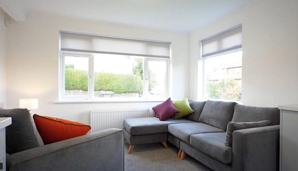 A bright and inviting living room featuring a c...