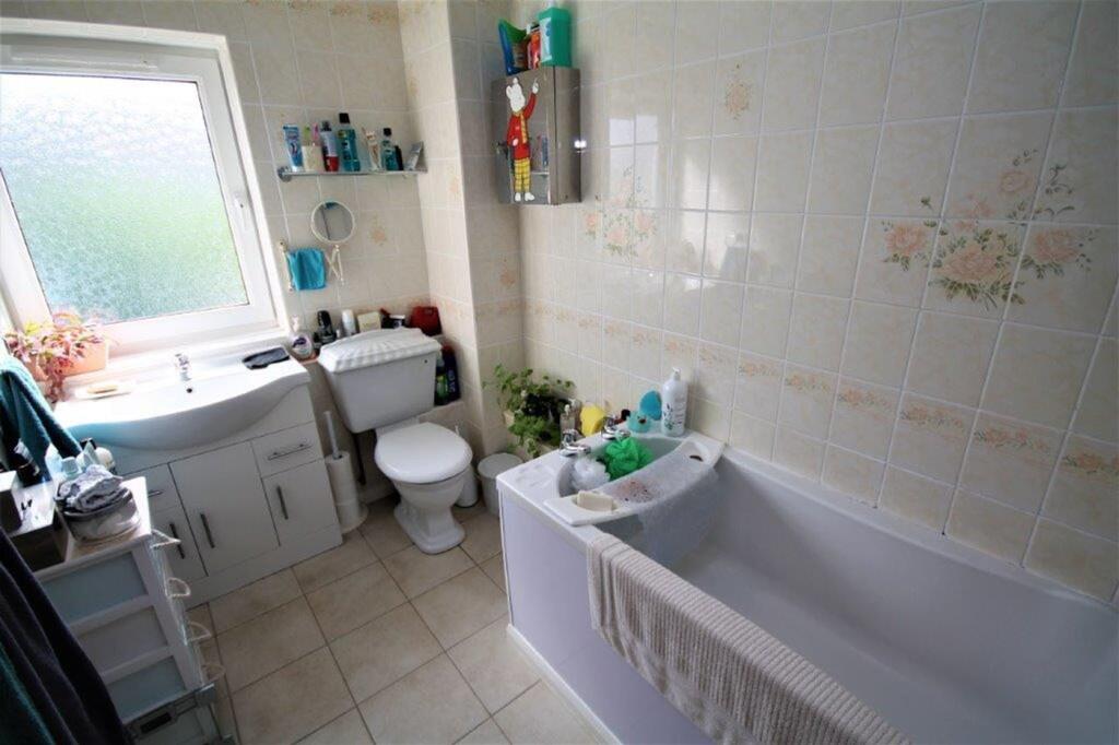 A bright and functional bathroom featuring a ba...