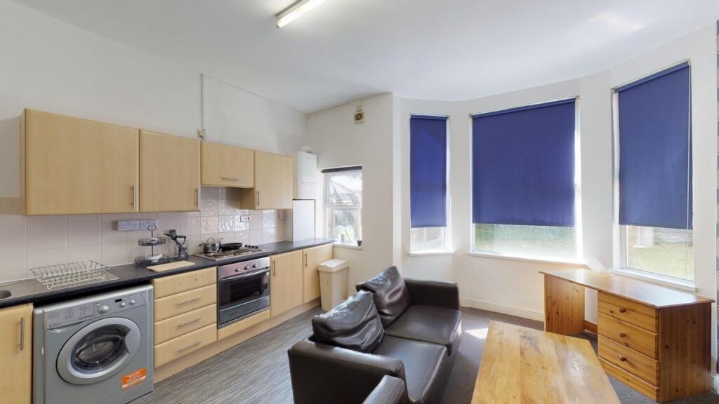 A bright and tidy kitchen featuring modern wood...
