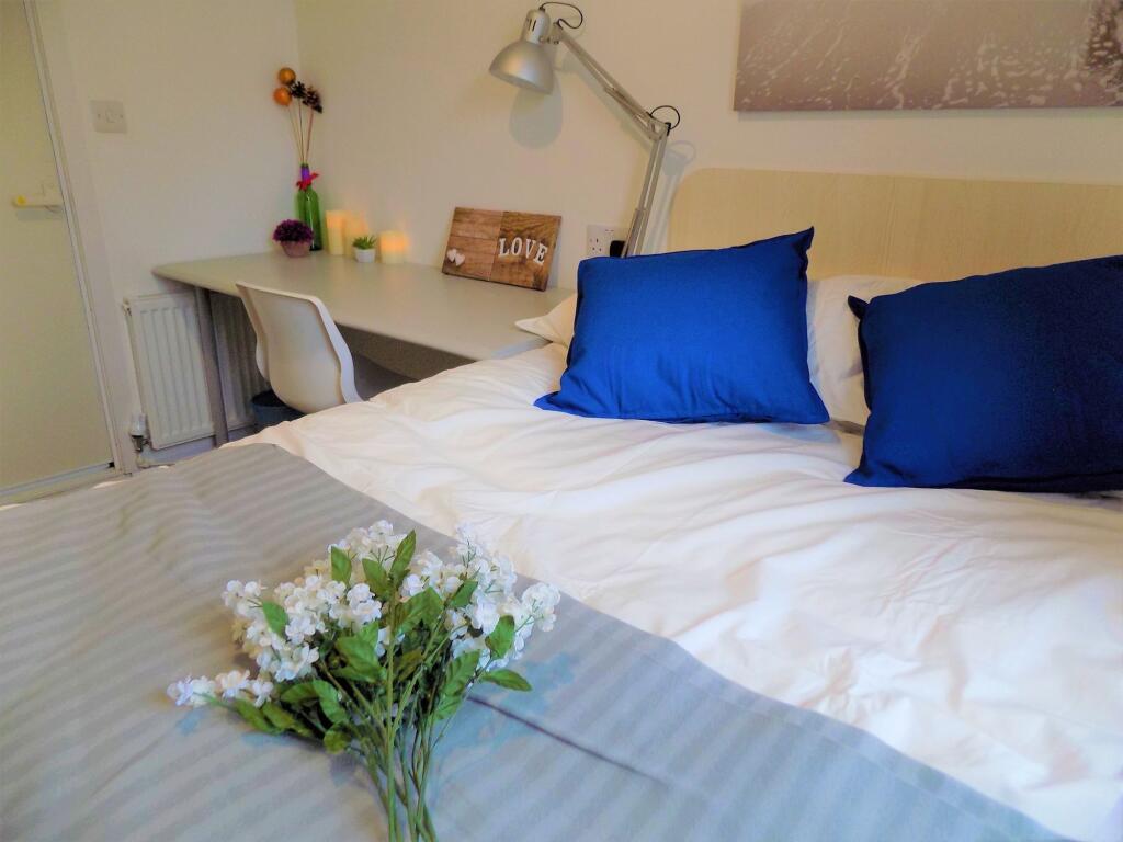 A cozy and neatly arranged bedroom featuring a ...