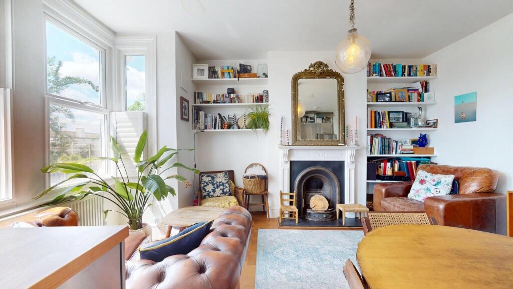 A bright and inviting living room featuring lar...